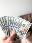 finance-money-closeup-hand-holding-dollars-finance-money-closeup-hand-holding-dollars-145442913.jpg